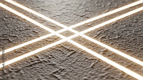 Abstract geometric lines of light on a textured surface background.