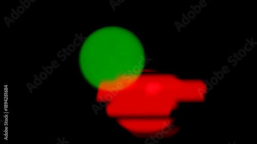 Abstract Red and Green Glowing Shapes Moving on Black Background, Blurred Light Motion