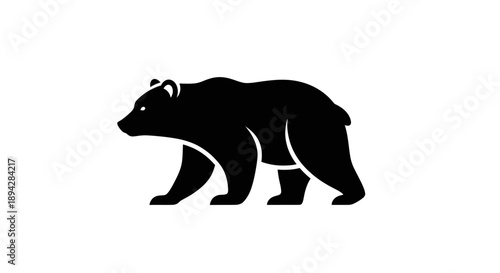 Silhouette of a bear walking alone on a white background viewed from the side