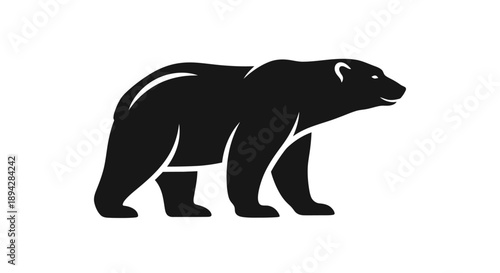 Black bear silhouette walking alone in a white environment viewed from the side