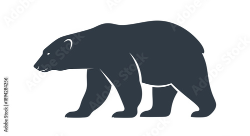 A large polar bear walking in a dark silhouette against a white background