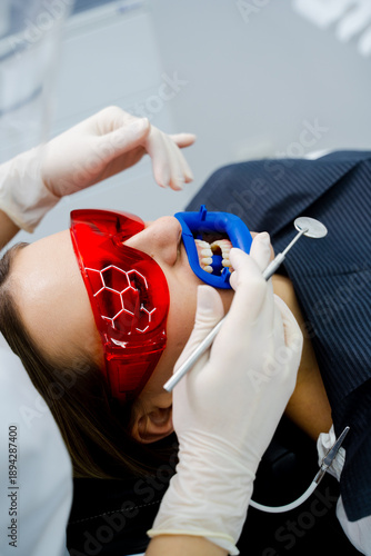 Fotografie Cheek retractor used by dentist to hold lips and cheeks for whitening procedure