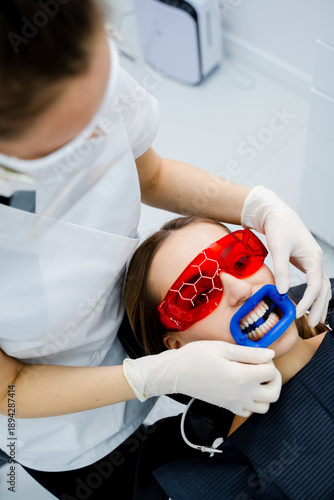 Tablou pe pânză Cheek retractor holds lips and cheeks back during dentist teeth whitening
