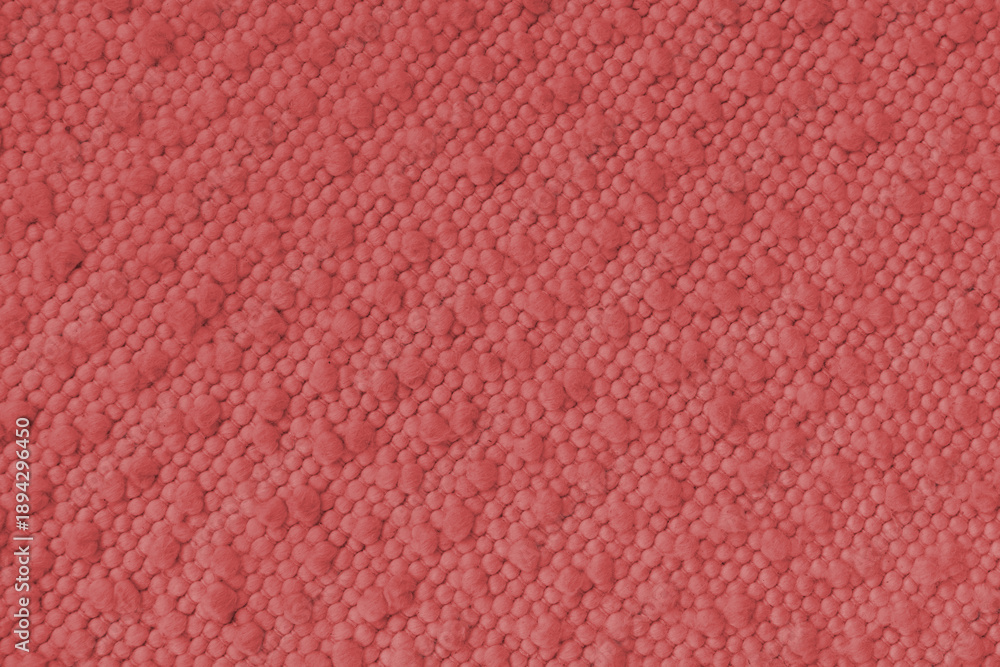Fototapeta premium Red jacquard upholstery fabric with raised fluffy pom pom pattern, weave creating rich textured cloth surface. Decorative textile background for furniture, interior design, upholstery backdrop