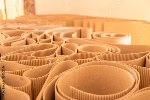 Abstract corrugated cardboard rolls in warm interior