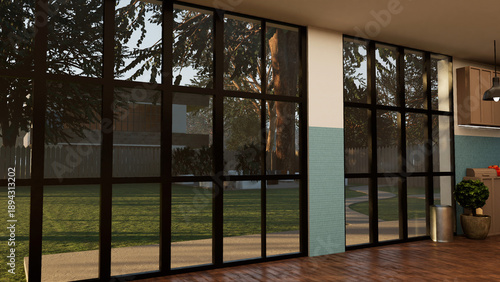 Large glass wall in modern home offering view of green backyard during sunny day. Floor to ceiling windows in sunlit room providing access to garden, contemporary interior design concept