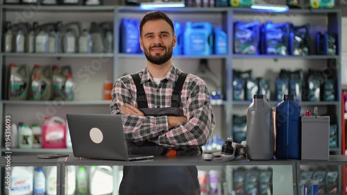 Confident auto parts store salesman smiling at the camera