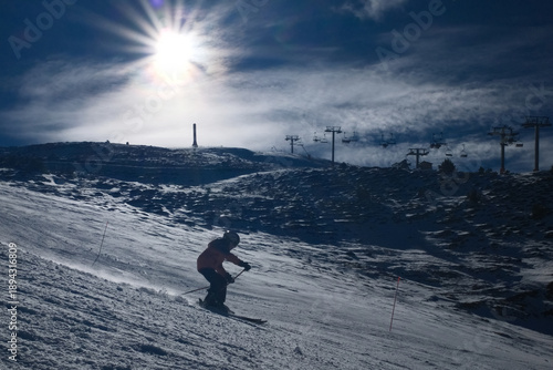 Skiers Going Down a Snowy Slope at Ski Resort in Winter