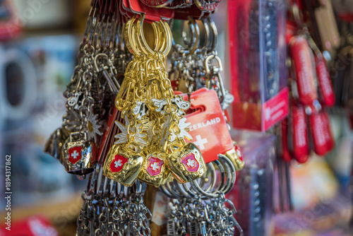 Φωτογραφία Gold and silver souvenir keychains with Swiss cowbells and edelweiss flowers are