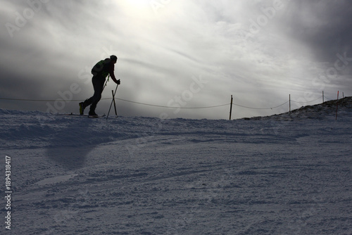 Skiers Going Down a Snowy Slope at Ski Resort in Winter