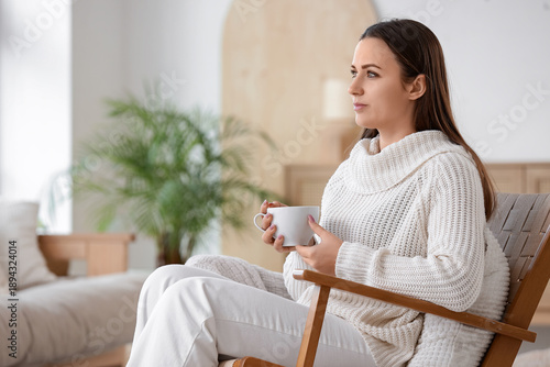 Young woman with cup of tea...
