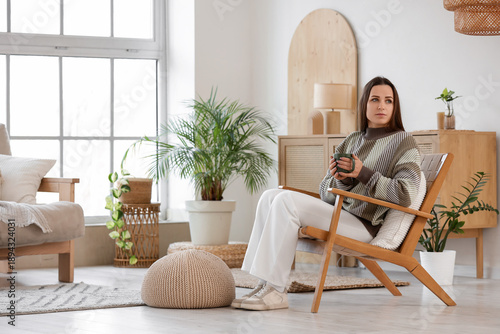 Young woman with cup of tea...