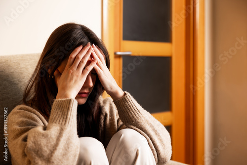 Woman experiencing stress, headache, and mental health issues