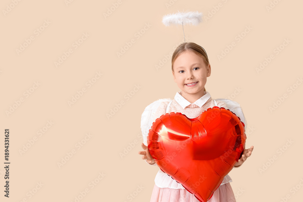 Fototapeta premium Cute little girl dressed as cupid with air balloon in shape of heart on beige background. Valentine's Day celebration