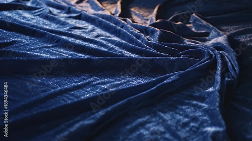Abstract blue fabric texture with folds and shadows, artistic background.