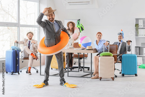 Group of funny business people with beach accessories ready for summer vacati...