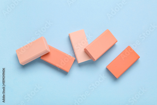 Pink rubber erasers on blue...