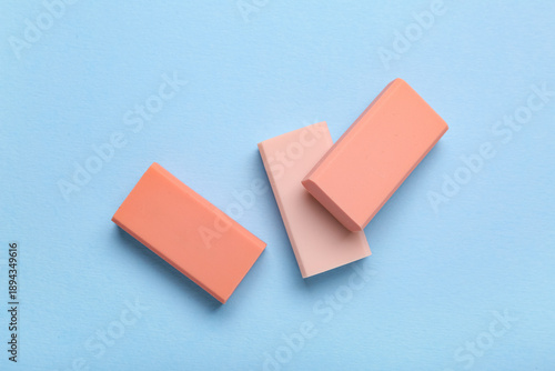 Pink rubber erasers on blue...