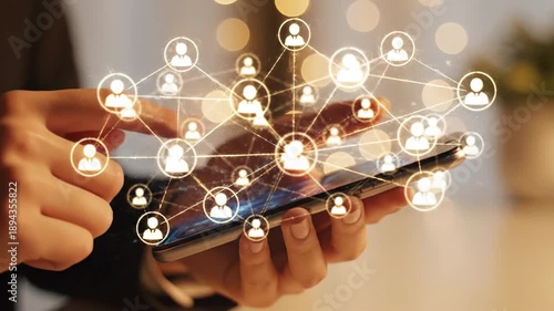 Close-up of a person's hands using a smartphone to connect with a glowing digital network of people, representing social media and online community