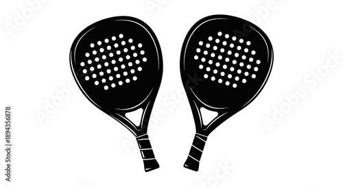 Two black padel rackets with perforated faces and wrapped handles, side by side on a white background, ready for a game.