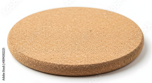 A round, light brown cork mat or coaster on a white background, isolated.