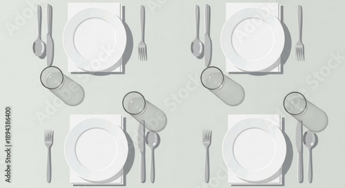 Elegant table setting with white plates and glasses on a light green background for dinner party or special occasion