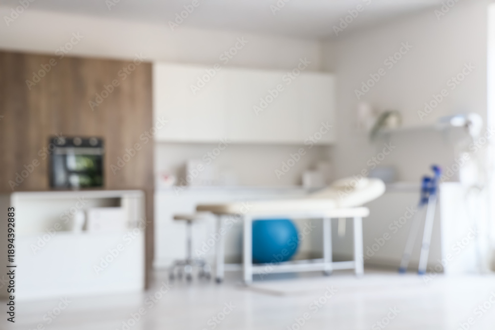 Naklejka premium Blurred view of physiotherapist's office with couch and counters