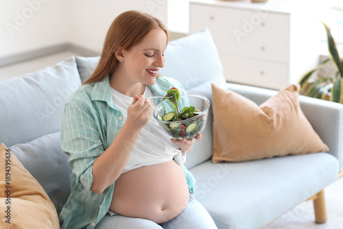 Young pregnant woman eating...
