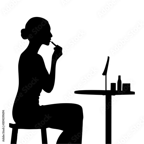 Black silhouette of a woman applying makeup at a dressing table
