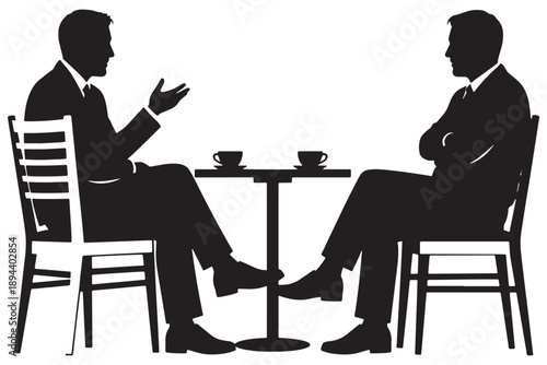 Two businessmen in suits having a conversation over coffee in a quiet setting.
