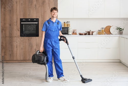 Young male janitor with mod...