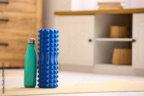 Foam roller with bottle of ...