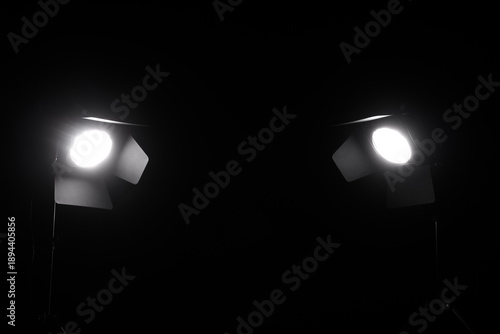Glowing studio light on bla...
