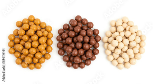 Three piles of chocolate coated nuts, crunchy snacks, sweet treats, isolated on transparent background