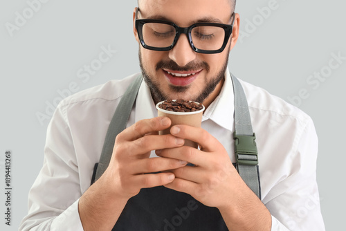 Young male barista with pap...