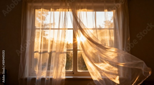 Golden light filtering through sheer curtains gently blowing in a sunlit window
