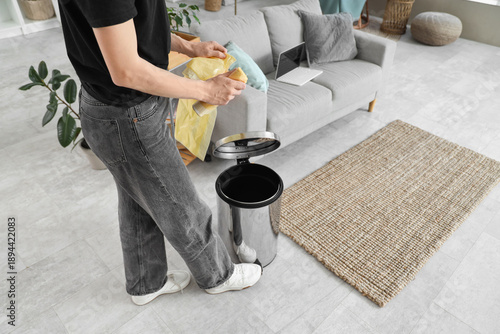 Woman tearing garbage bag n...