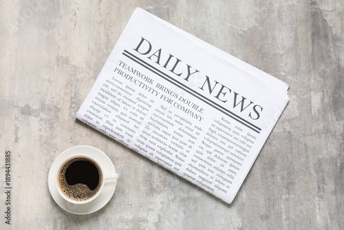 Daily newspaper with cup of...