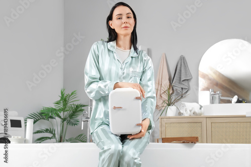 Young woman holding cosmeti...