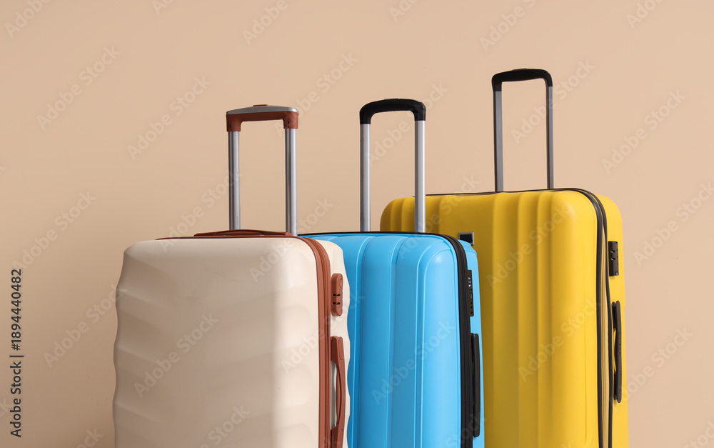 Obraz premium Packed suitcases near beige wall