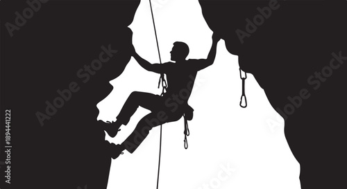 Silhouette of a rock climber ascending a steep mountain