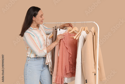 Young woman near rack with ...