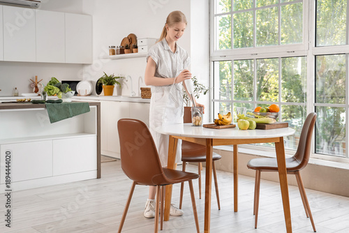Young woman with blender an...