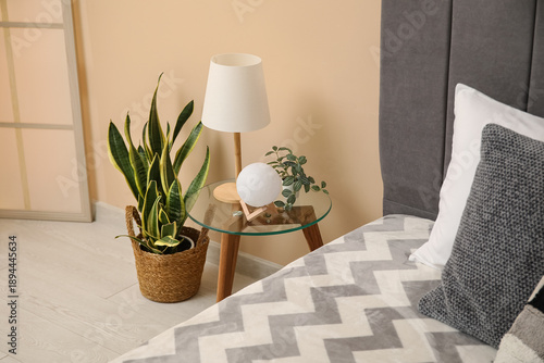 Bedside table with lamp nea...