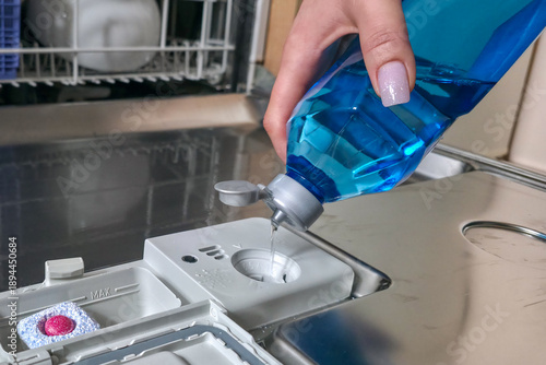 Loading the dishwasher. Tablets and rinse aid to start the dishwasher cycle.