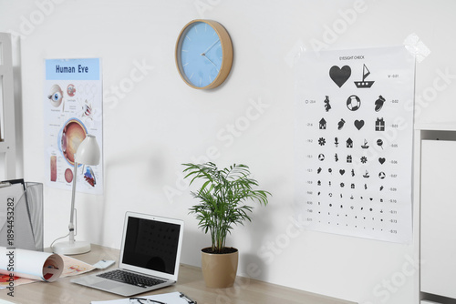 Eye test chart on light wal...