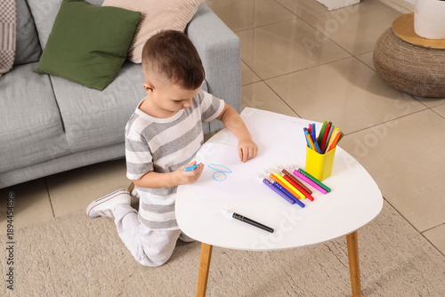 Adorable little boy drawing...
