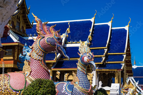 Showcasing a vibrant temple with its intricate design against a backdrop of a brilliant sky, embodying the essence of peace and heritage at Chiang Mai Thailand.