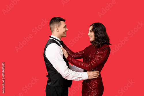 Loving young couple on red ...