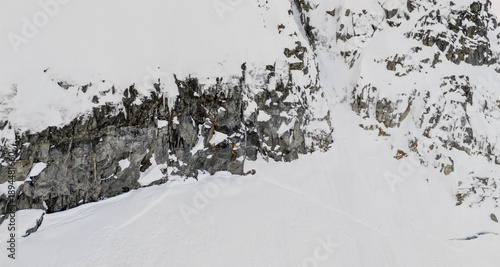 Fotografie Snowy Mountain Cliffs and Snow Field in Rugged Terrain, BC, Canada Landscape Alp